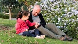 Autistic girl and tutor on therapy in the park