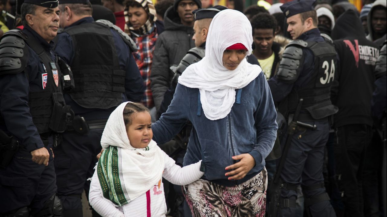 Refugees get ready to leave Calais as demolition begins at the Jungle migrant camp Tuesday. 