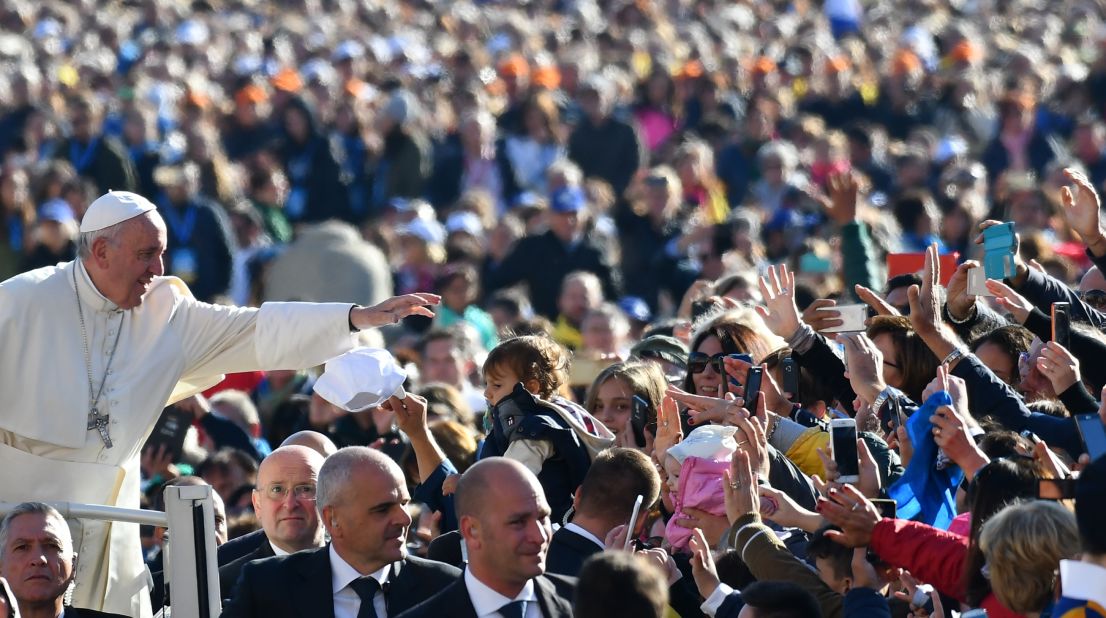 Pope Francis salutes the faithful upon his arrival in St. Peter's Square at the Vatican for the Special Jubilee Papal Audience on Saturday, October 22, 2016.