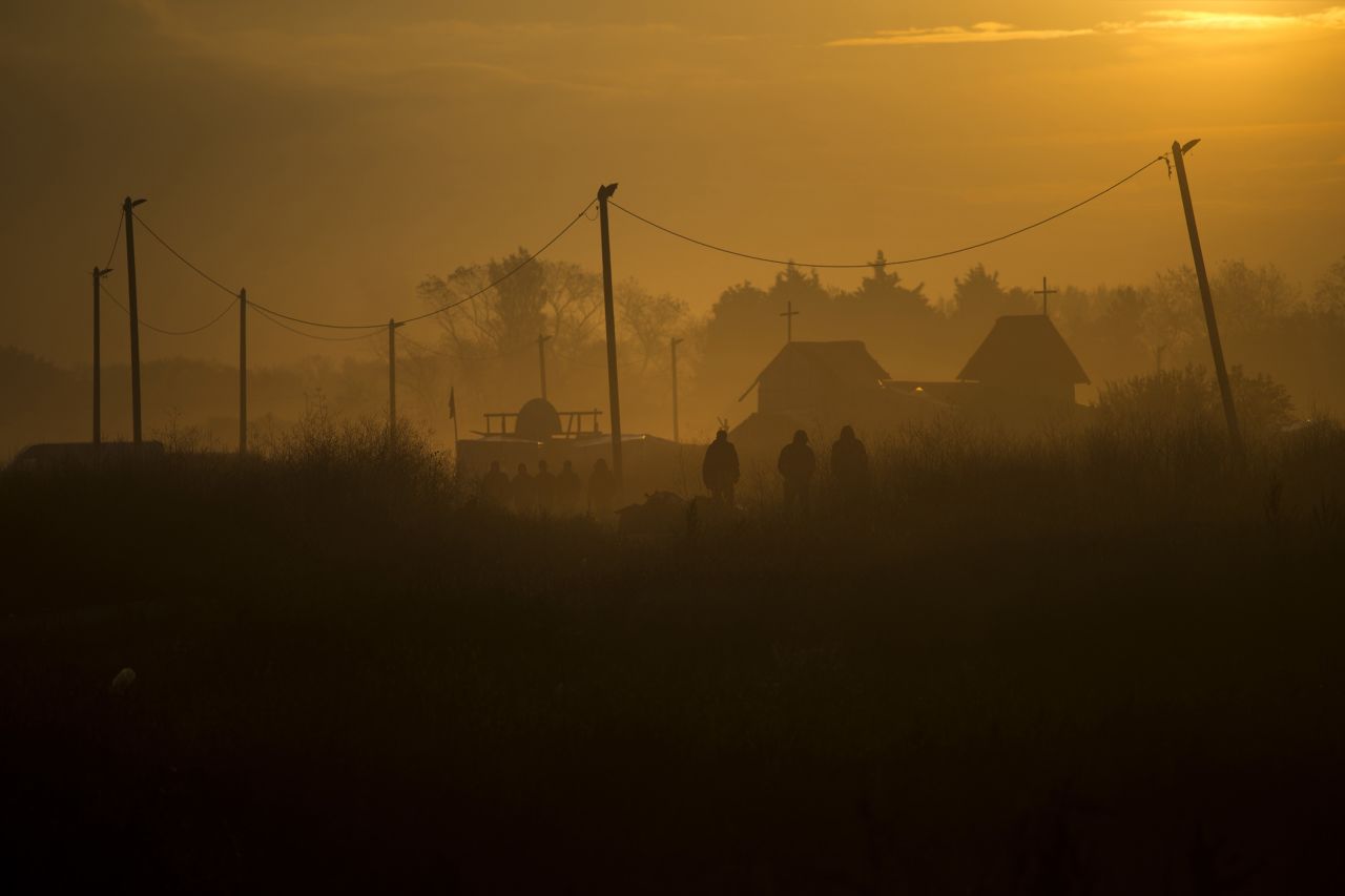 People walk through the camp on October 25.