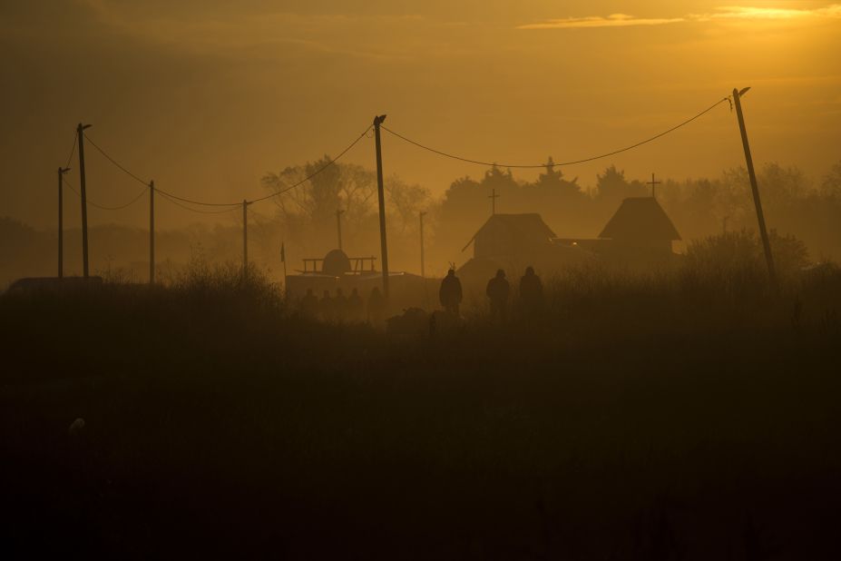 People walk through the camp on October 25.