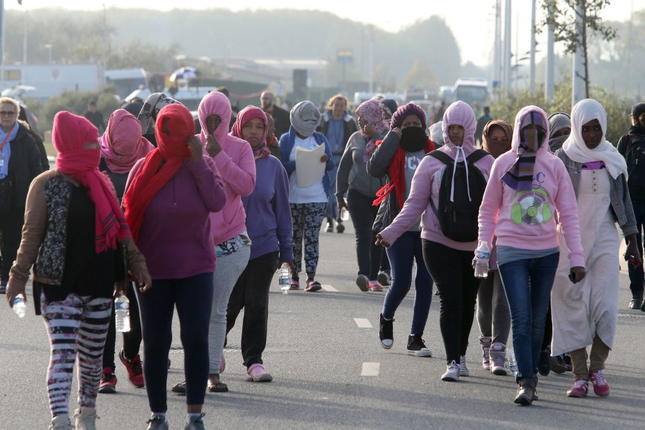 Women arrive at a meeting point determined by authorities managing the evacuation of the camp.