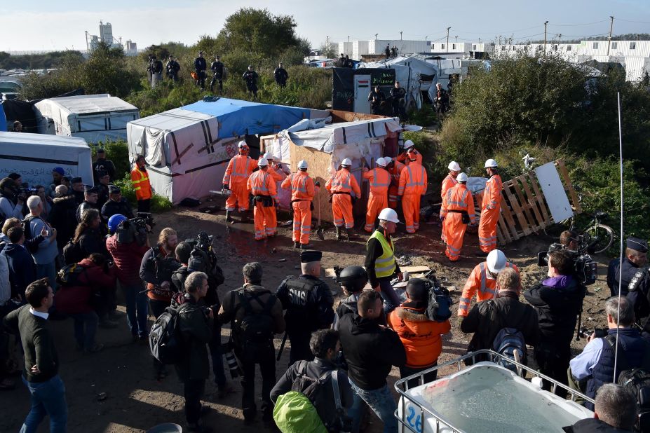 Workers begin demolishing shelters in the camp on October 25.