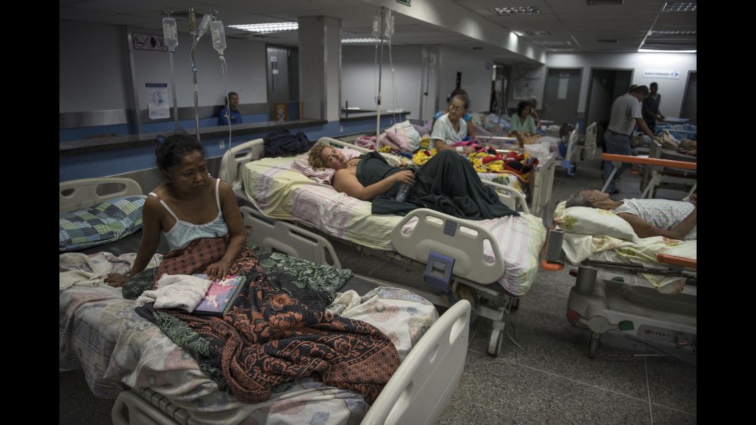 Patients lie on beds in the emergency room of a hospital in Barquisimeto on Monday, Feb. 22, 2016. In Barquisimeto, the hub of Venezuela's farming heartland, shoppers line up for food, neighborhoods are dark from rolling blackouts and hospitals are so crowded that the sick sometimes share beds. 