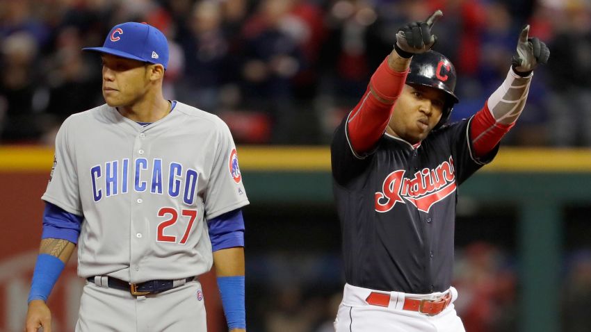 Jose Ramirez of the Cleveland Indians reacts after hitting a double during the sixth inning as Addison Russell of the Chicago Cubs looks on in Game One of the 2016 World Series at Progressive Field on October 25, 2016 in Cleveland, Ohio.