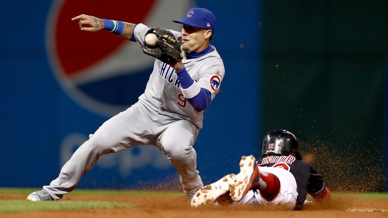 Javier Baez of the Cubs tags out Cleveland's Francisco Lindor as he tries to steal second base in Game 1.