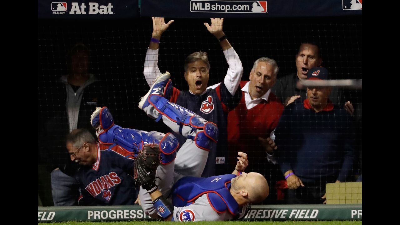 Cubs catcher David Ross falls after catching a pop fly by Cleveland's Lonnie Chisenhall in Game 1.