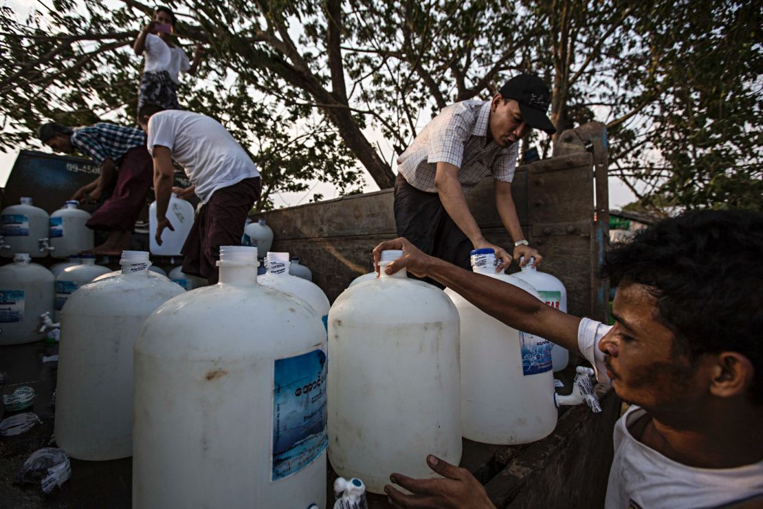 Volunteers prepare the clean water donation service in Dala, Burma.