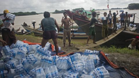 Volunteers load food supplies onto boats for flood-affected residents in Myanmar's Irrawaddy region in August 2015. 