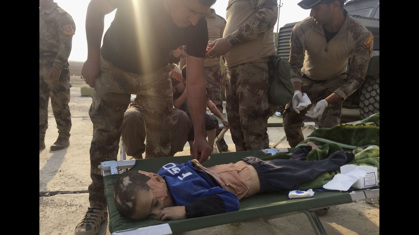 Soldiers give first aid to an injured boy in Tob Zawa on October 25. 