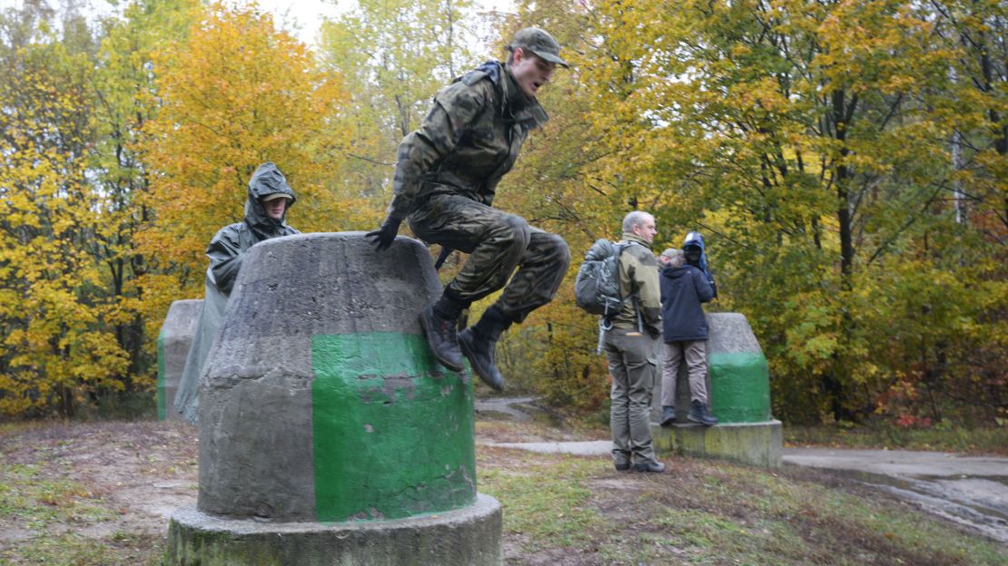 Recruits run through a training course near Warsaw.