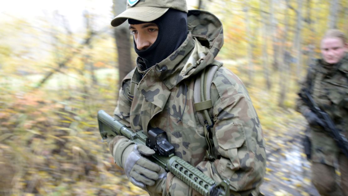 Militia members train in a forest near Warsaw in October.