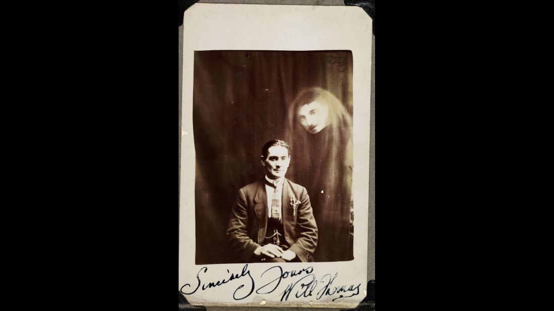 A man's face appears in a haze of drapery next to Will Thomas, a medium from Wales in the early 20th century. The photo was taken by William Hope, a paranormal investigator who was popular for his spirit photography in England. His photos of supposed ghosts were later proved to be fake -- the result of double- and triple-exposure techniques -- but he continued the practice until his death in 1933.