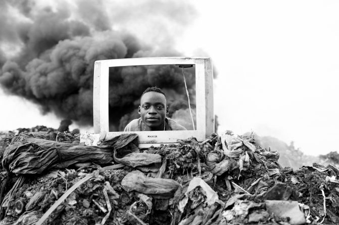 A boy plays behind a discarded TV frame. Electronic waste is burned at the site, explains Macilau, releasing hazardous chemicals into the environment. 