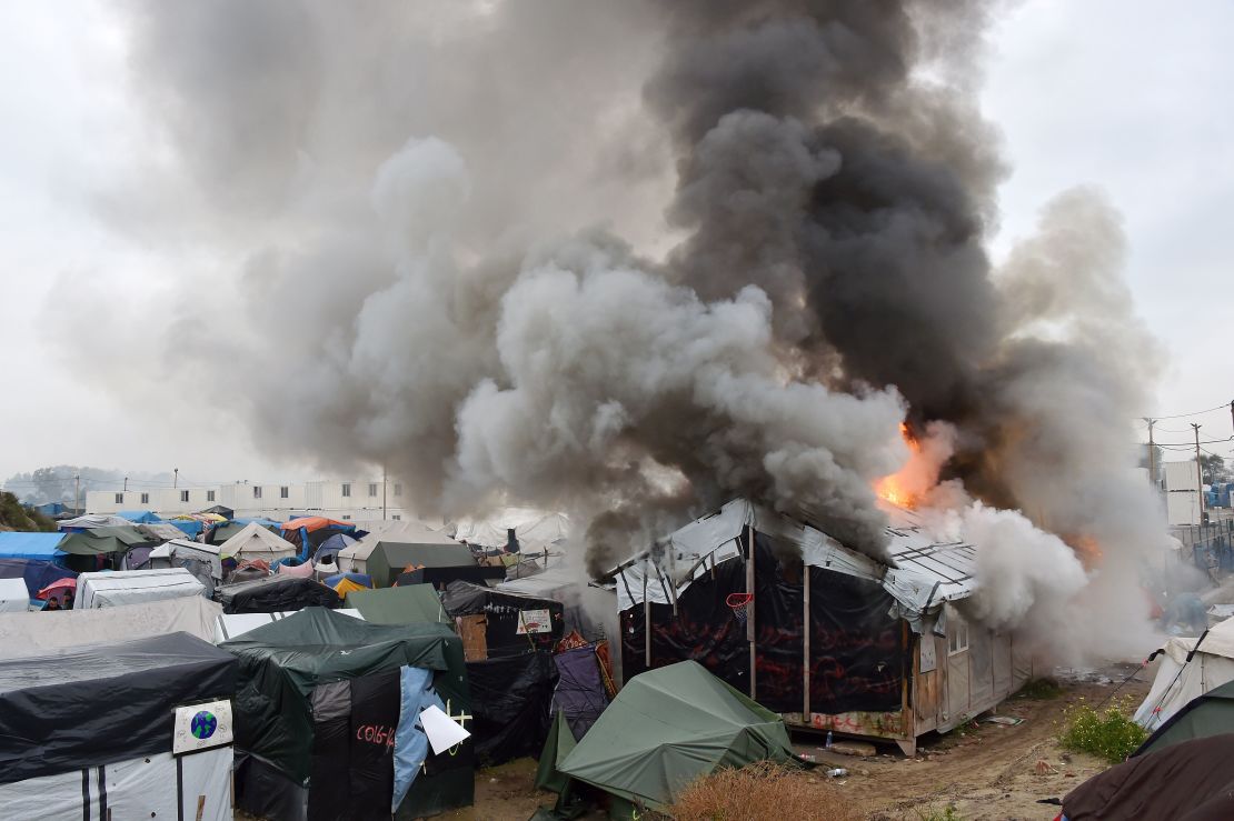 Migrants torched temporary shelters at The Jungle on Wednesday, authorities said.