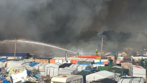 Firefighters struggle to control the dozens of fires tearing through the camp.
