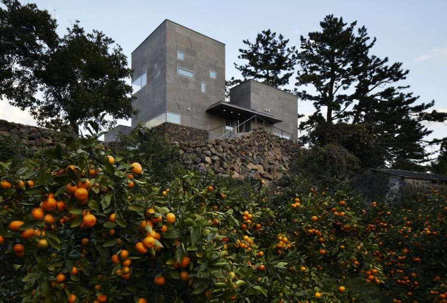 Found on the South Korean island of Jeju, this concrete and volcanic-stone house was built on a citrus farm. It has a bowed roof that nods to the island's traditional housing, while maintaining an interconnected relationship with the outside. "A house in Korea needs to respond to the changing weather," says architect Doojin Hwang. "The interior becomes the exterior and vice versa."