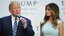 Donald Trump speaks during a ribbon cutting ceremony as his wife Melania looks on at the grand opening of the Trump International Hotel in Washington, DC on October 26, 2016.
