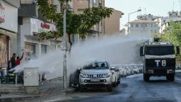 Turkish anti-riot police use a water cannon to disperse protesters on October 26, during a demonstration against the detention of the Kurdish-majority city's co-mayors in Diyarbakir.
