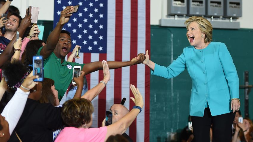 A supporter takes a selfie as he touches hands with Democratic presidential nominee Hillary Clinton at a rally at Palm Beach State College in Lake Worth, Florida, October 26, 2016. 