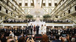 Donald Trump (C) and his family (L-R) son Donald Trump Jr, son Eric Trump, wife Melania Trump and daughters Tiffany Trump and Ivanka Trump prepare to cut the ribbon at the new Trump International Hotel October 26, 2016 in Washington, DC.