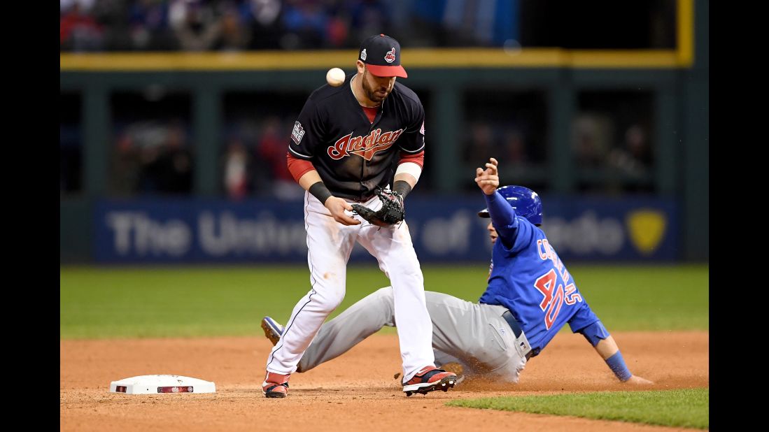 Jason Kipnis of the Indians is unable to handle the ball as Willson Contreras of the Cubs slides safely into second during the seventh inning in Game 2.