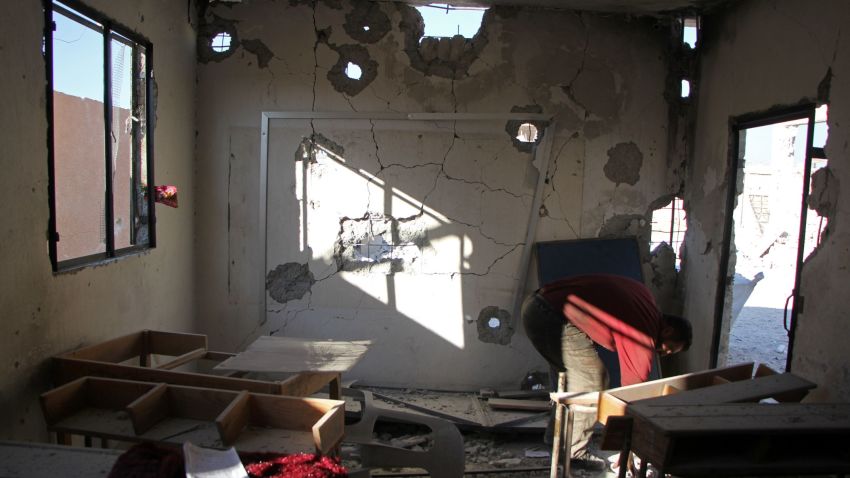 A Syrian man checks the damage at a school after it was hit in an air strike in the village of Hass, in the south of Syria's rebel-held Idlib province on October 26, 2016. / AFP / Omar haj kadour        (Photo credit should read OMAR HAJ KADOUR/AFP/Getty Images)