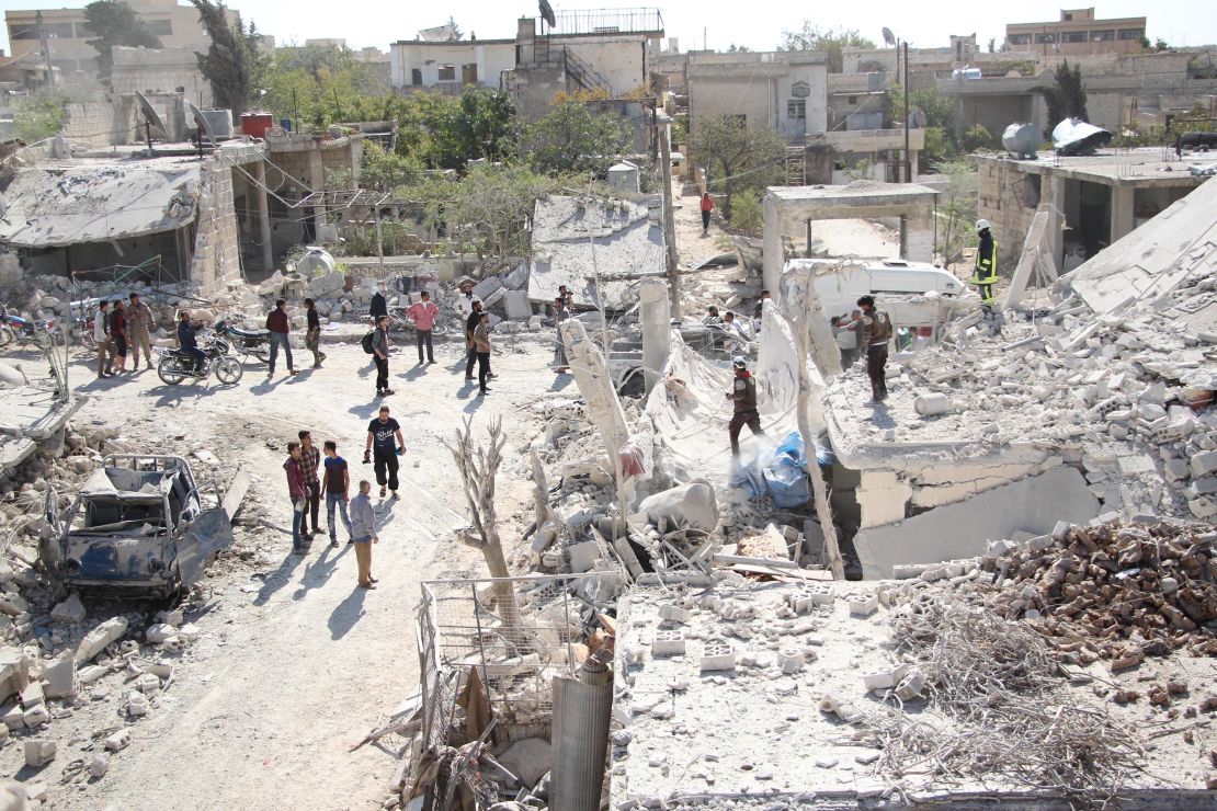 Rescuers from the Syrian Civil Defense and civilians search for victims following the school strikes.