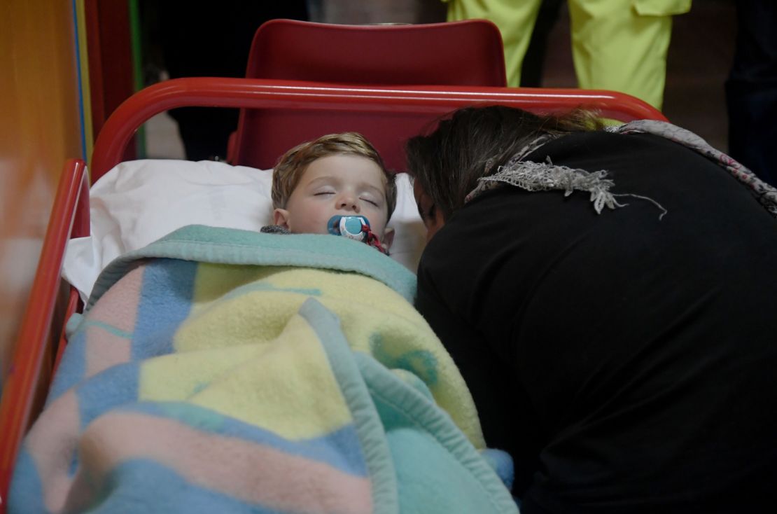 A child sleeps in a secured area of Visso after earthquakes rocked central Italy.