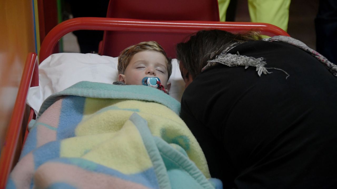 A child sleeps in a secured area of Visso after earthquakes rocked central Italy.