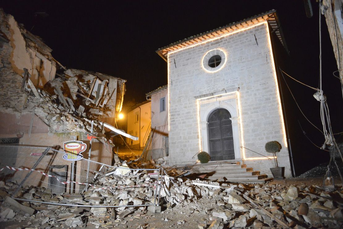 The Church of San Sebastiano stands amid damaged houses in Castelsantangelo sul Nera, Italy, following a pair of strong aftershocks that shook central Italy late Wednesday.
