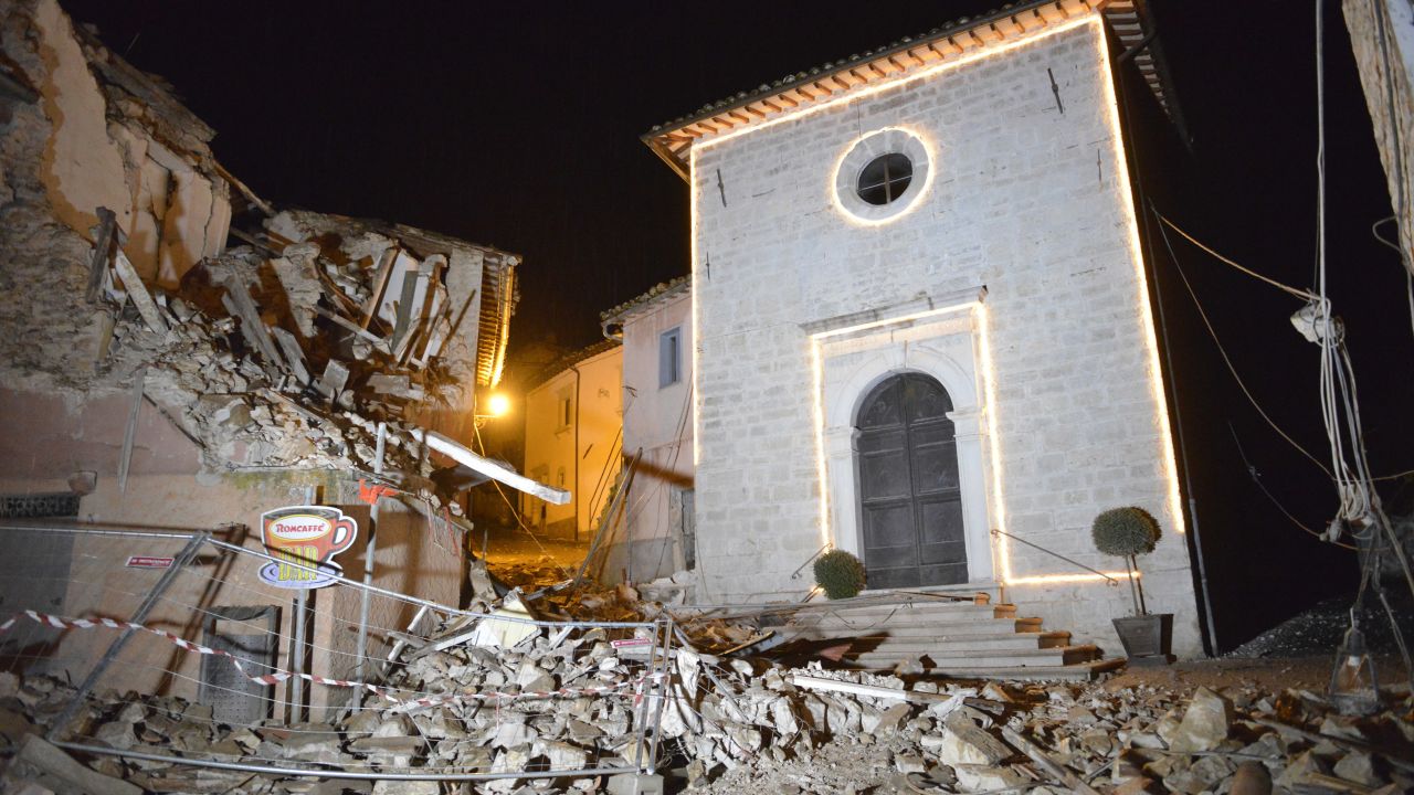 The Church of San Sebastiano stands amid damaged houses in Castelsantangelo sul Nera, Italy, following a pair of strong aftershocks that shook central Italy late Wednesday.