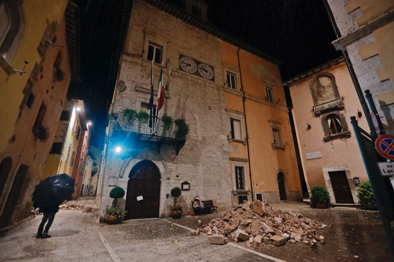 People wander around Visso on October 27 after the quake destroyed part of their neighborhood. 