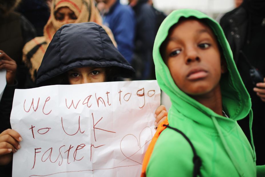 Women and children protest their case to the UK government from the Jungle, as authorities continue the destruction of the camp on October 26.