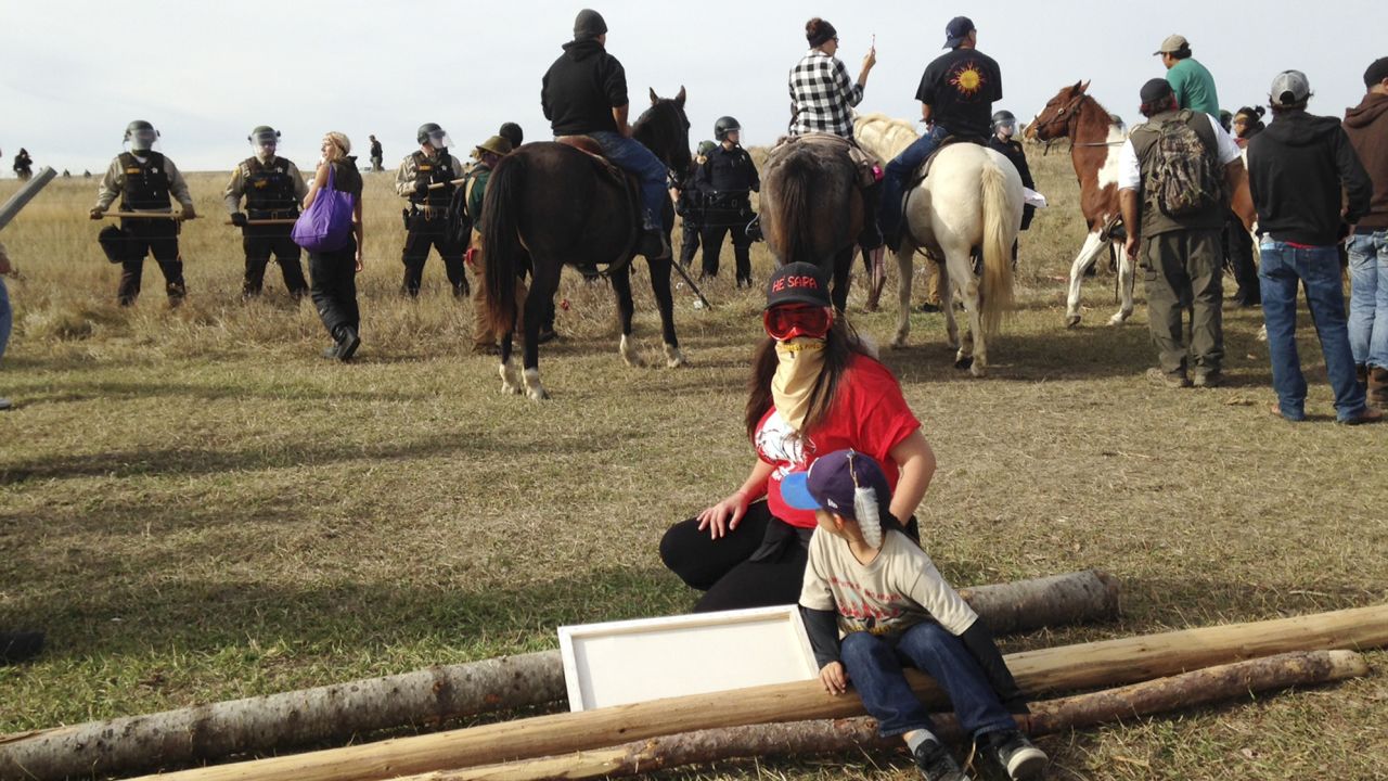 Protesters resist efforts to be moved from a camp in the path of pipeline construction Thursday.