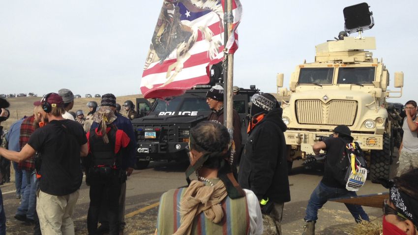 Dakota Access pipeline protesters defy law enforcement officers who are trying to force them from a camp on private land in the path of pipeline construction on Thursday, Oct. 27, 2016, near Cannon Ball, N.D. The months-long dispute over the four-state, $3.8 billion pipeline reached a crisis point when the protesters set up camp on land owned by pipeline developer Energy Transfer Partners. The disputed area is just to the north of a more permanent and larger encampment on federally-owned land where hundreds of protesters have camped for months.