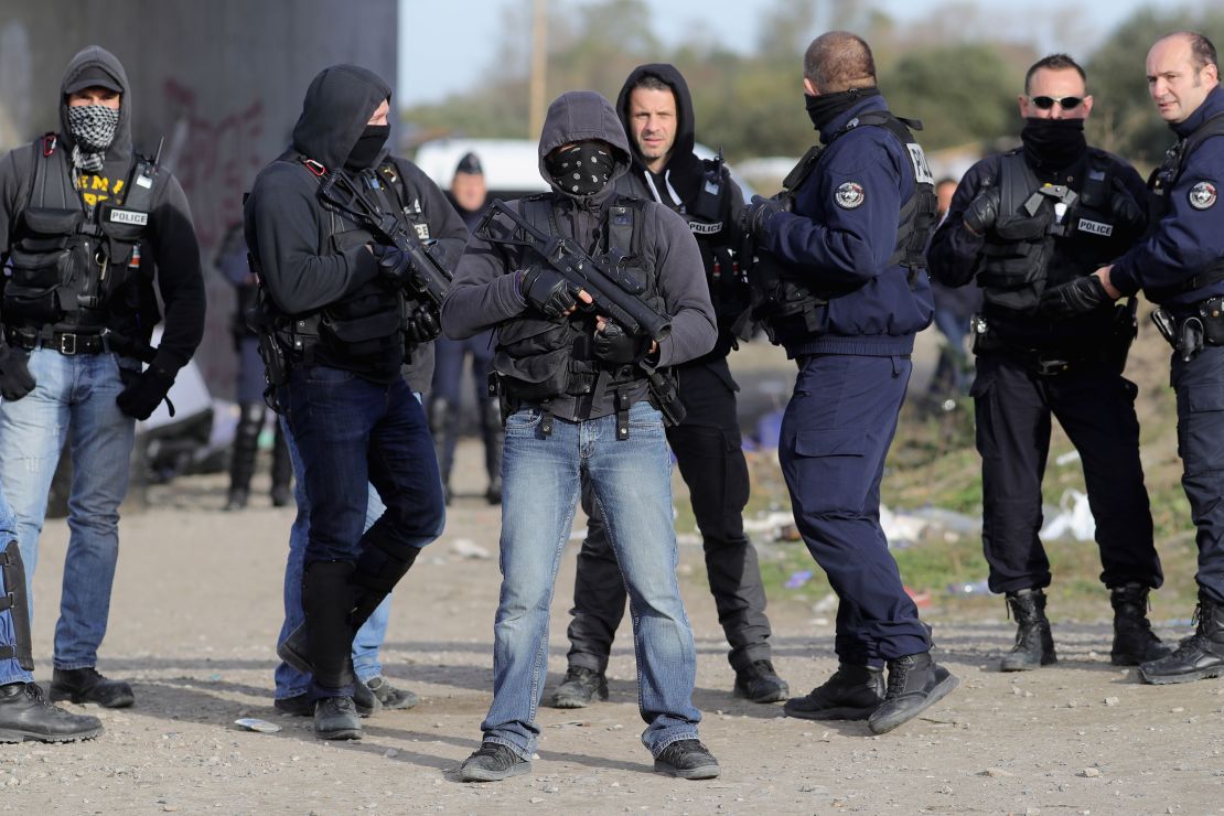 French police clear the main entrance and road into the Calais 'Jungle' migrant camp.