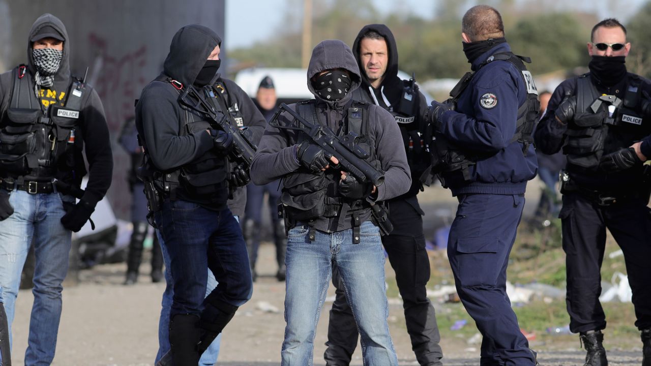 French police clear the main entrance and road into the Calais 'Jungle' migrant camp.