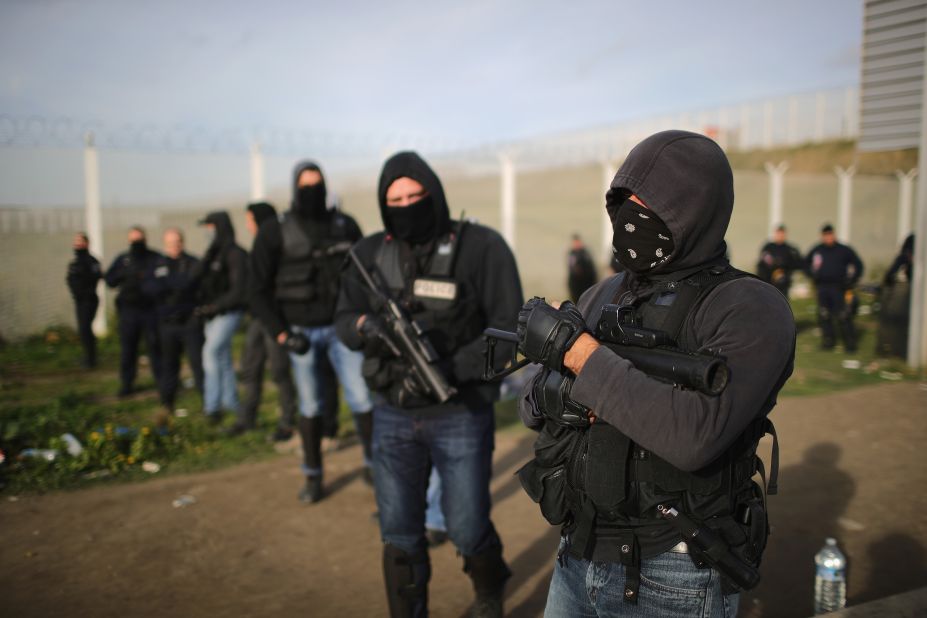 Riot police guard the main entrance to the Jungle on Thursday, October 27. Authorities have declared the camp clear, but aid workers say that up to 100 unaccompanied minors remained with nowhere to sleep.