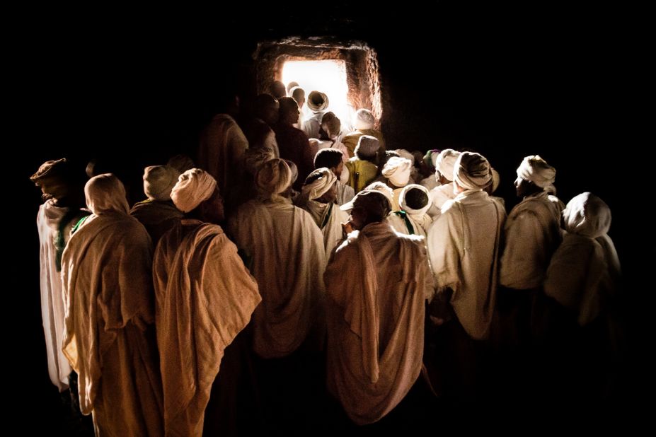 Pilgrims waiting to emerge from inside a tunnel at Bet Girogis or the House of St George, Lalibela. This hand-carved, 12th century church is connected to 12 other churches by a series of tunnels, designed to protect medieval worshipers from attacks, but also to symbolize the movement of pilgrims from darkness to light.