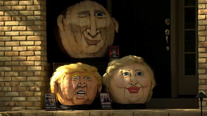 Behold Trumpkin the giant pumpkin! Jeanne Moos reports Trumpkin meets Clintkin in the political pumpkin patch.     Pumpkin Trumpkin    Pumpkins have gone political as the nation's most famous pumpkin portraitist displays this year's characters...Trumpkin, Clintkin, and Putkin. Jeanette Paras has been "pumpkinizing" celebs since 1988 and this year she's chosen 3 of the hottest names in news, the Donald, Hillary and Vladimir. All 3 are on display on her Dublin, Ohio porch. She's not really an artist but her creations have a cartoon quality that makes them funny. We have sound with Jeanette plus pix of her greatest hits from Kanye to Kim Jung Un. Might also briefly detour to Halloween masks of the candidates. Usually the best selling mask wins the actual election. Trump is outselling Hillary but retailers say he's being bought by both supporters and those who want to mock him, throwing off predictions. Plus 95% of rubber masks are bought by men. Chances are guys don't want to don a dress or pantsuit and dress up as Hillary.
