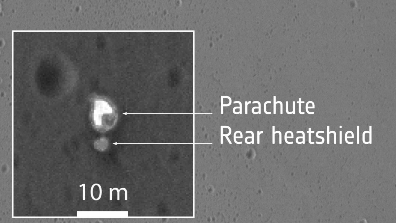 The zoomed insets provide close-up views of what are thought to be several different hardware components associated with the Schiaparelli module's descent to the martian surface.