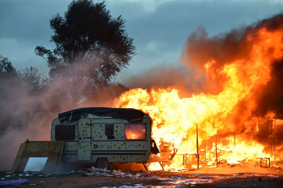 A trailer burns in the Calais "Jungle" early on Friday, October 28.