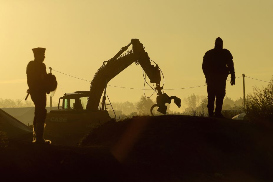 Heavy machinery is used to remove debris from the camp on October 27.