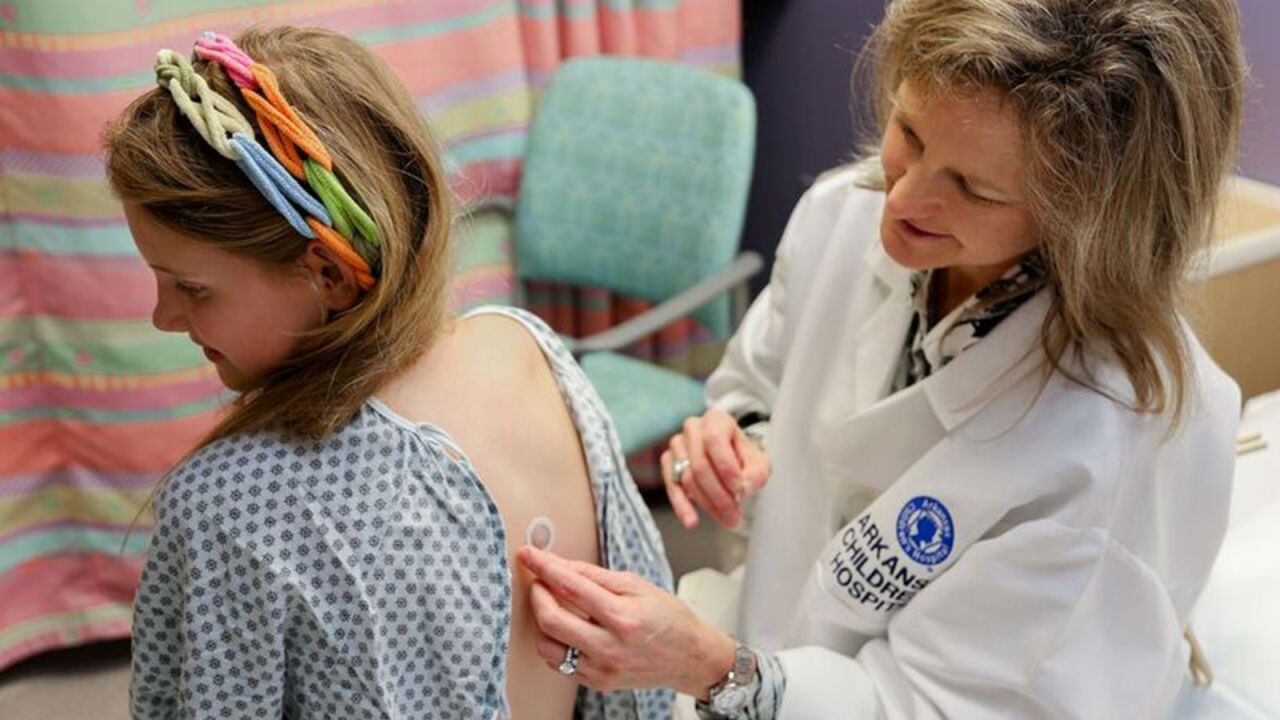 Dr. Stacie Jones applies a peanut patch to a clinical trial participant at Arkansas Children's Hospital. 