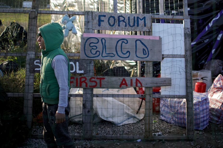 A young migrant stands outside the Calais camp school house on October 28. Minors who were not moved to safe houses outside of the Jungle earlier in the week were let back into the camp to shelter in the makeshift school for the night.<br />