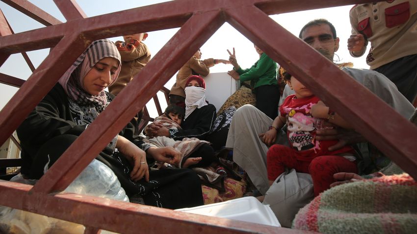 An Iraqi family sits in a vehicle driving near Sin al-Dhuban village, some 40 kilomtres south of Mosul, after they fled the Hammam al-Alil area on October 27, 2016, as government forces take part in an operation to retake the main hub city from the Islamic State (IS) group jihadists.
The United States said that up to 900 Islamic State group jihadists have been killed in the offensive to retake Iraq's Mosul, as camps around the city filled with fleeing civilians.
 / AFP / AHMAD AL-RUBAYE        (Photo credit should read AHMAD AL-RUBAYE/AFP/Getty Images)