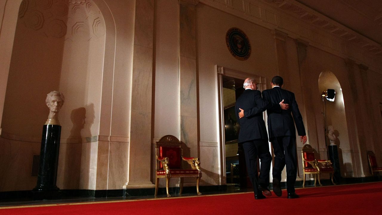Biden and Obama put their arms around each other after Obama's <a href=