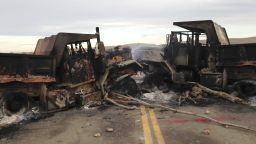 The burned hulks of heavy trucks sit on Highway 1806 near Cannon Ball, N.D., on Friday, Oct. 28, near the spot where protesters of the Dakota Access pipeline were evicted from private property a day earlier. Authorities say protesters burned several pieces of construction equipment Thursday during a chaotic confrontation with law enforcement. 