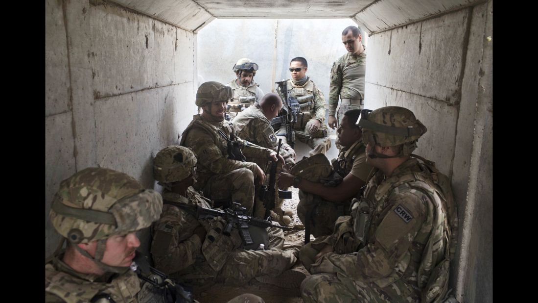 U.S. military personnel take cover in a bunker after a mortar alarm was sounded at a coalition air base in Qayyara on Friday, October 28.